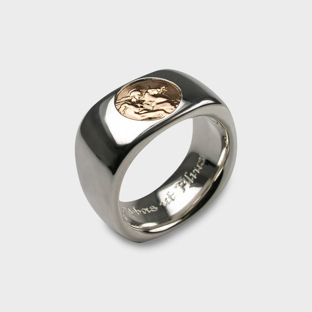 A silver ring with an ancient coin set in the centre.